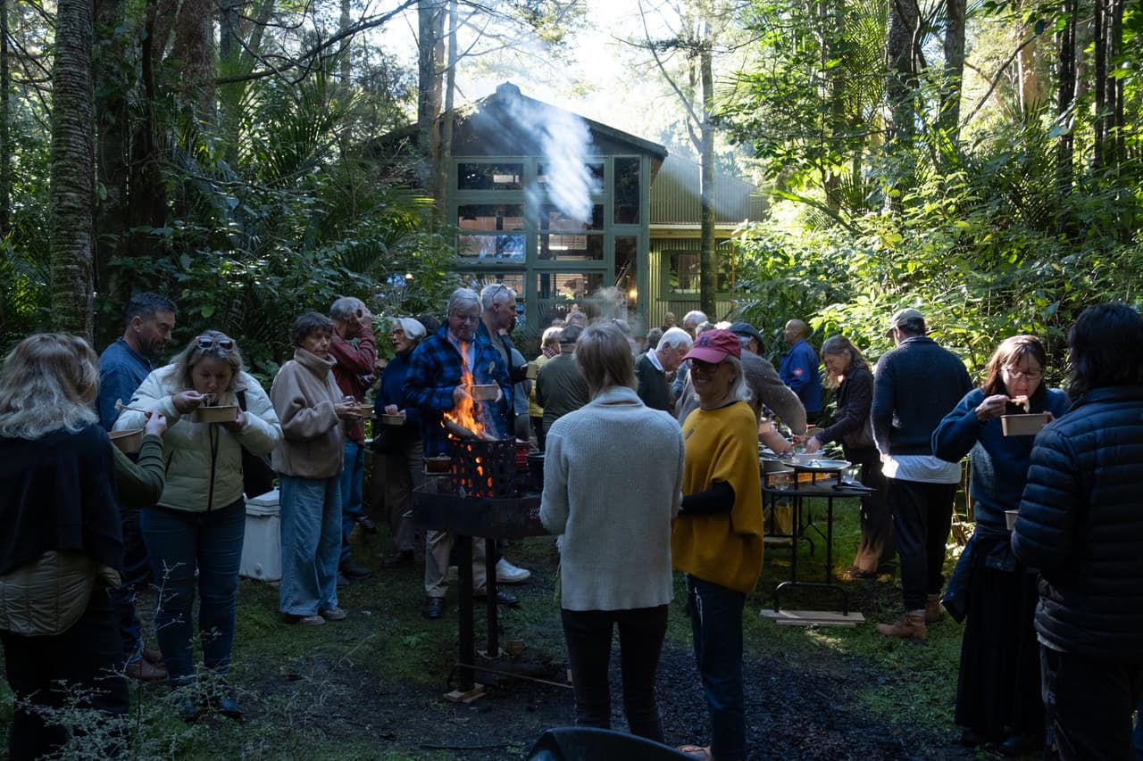 A gathering around fire at the SYML studio in Matakana